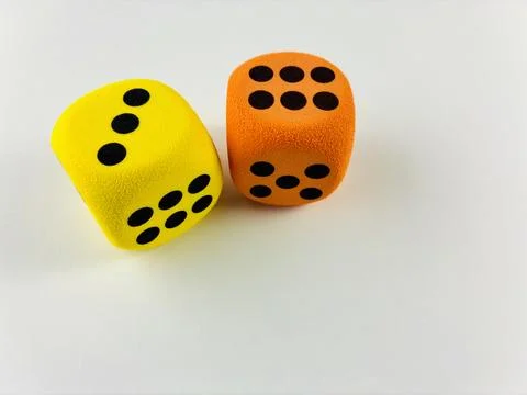 Yellow and Orange Dice Symbolizing Luck, Chance and Strategy Stock Photos