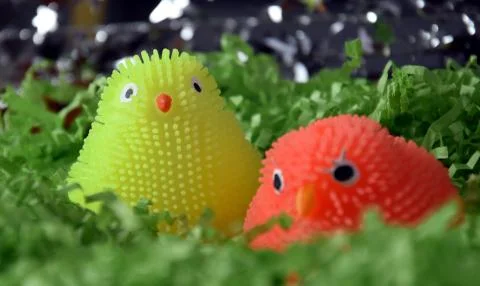 Yellow and orange plastic easter chicken figures in green nest. Happy Easte.. Stock Photos