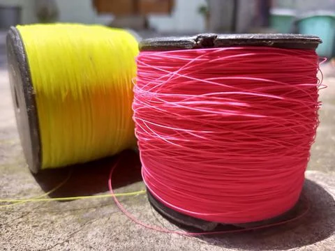 A yellow and pink kite string Stock Photos