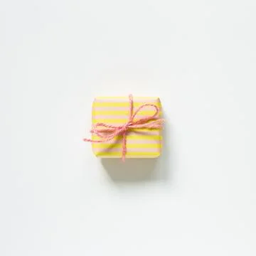 Yellow and pink stripe pattern gift box isolated on white background Stock Photos