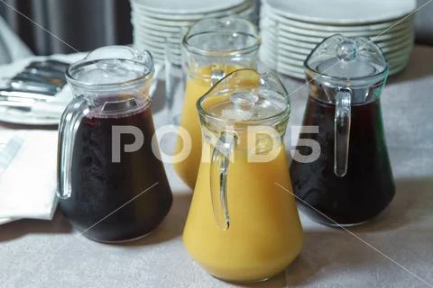 Yellow and red Glass Pitcher . yellow and red smoothie juice . Delicious oran Stock Photos