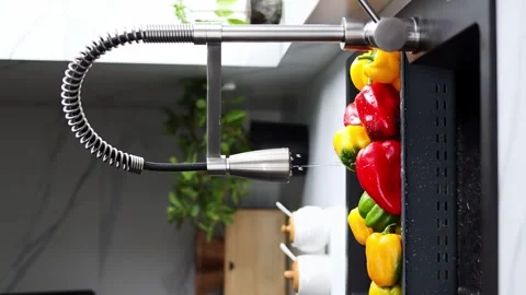 Yellow and red pepper are washed in a special tray for vegetables Stock Footage 241077650