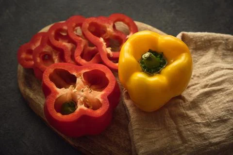 Yellow and red peppers on the cutting board 스톡 사진