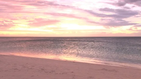 Yellow and red sunset over shimmering ocean beach Video stock 74088295