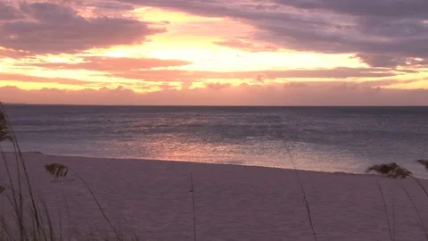 Yellow and red sunset over shimmering ocean beach Video stock 74088315