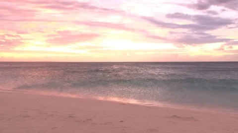 Yellow and red sunset over shimmering ocean beach Video stock 74088339