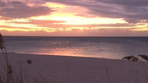 Yellow and red sunset over shimmering ocean beach Video stock 74088359