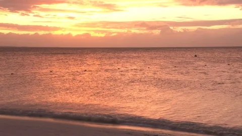 Yellow and red sunset over shimmering ocean beach Video stock 74088369