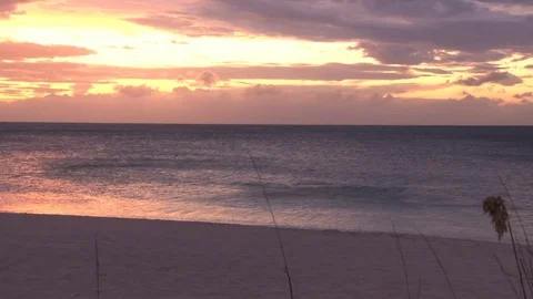 Yellow and red sunset over shimmering ocean beach Video stock 74088393