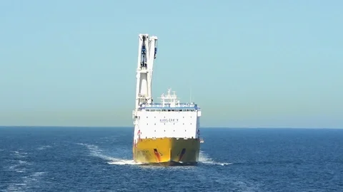 Yellow and white floating crane vessel sails on sea Stock Footage 113458939