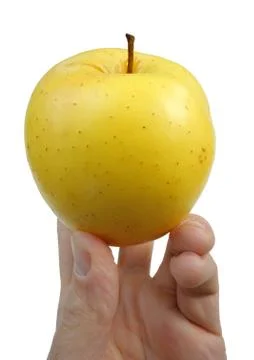 Yellow apple in the hand Stock Photos