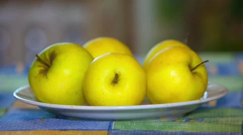 Yellow apples in a bowl on a table Stock Footage 49921502