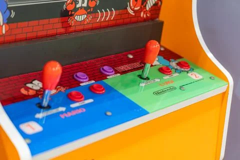 Yellow arcade game machine with control panel, red and black borders, color.. Stock Photos