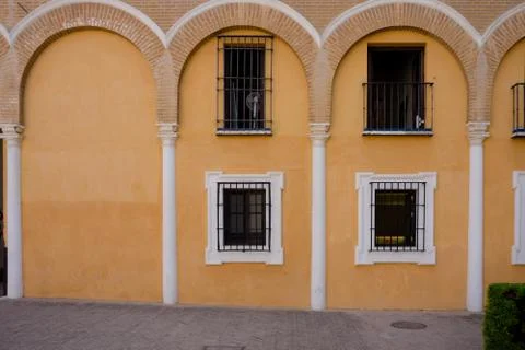 Yellow arches above the balcony window in Seville, Spain, Europe Stock Photos