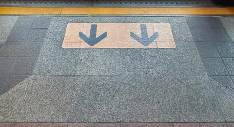 Yellow arrow direction points to exit of door. Stock Photos
