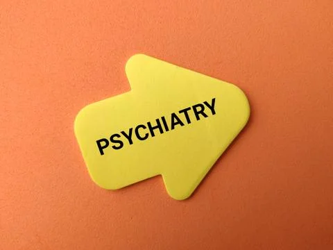 A yellow arrow note featuring the text PSYCHIATRY points diagonally upward .. Stock Photos
