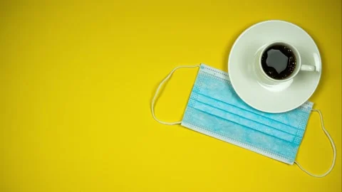 Yellow background with coffee cup and protecting mask. Stop motion animation Video stock 140360885