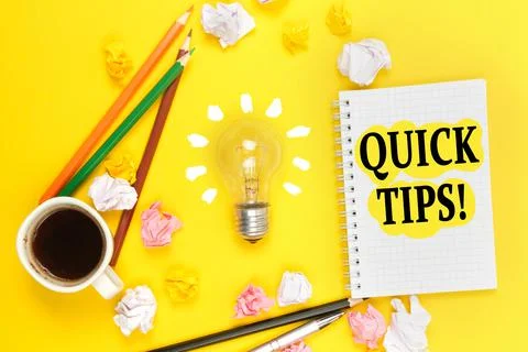 On a yellow background, a cup of coffee, a light bulb, pencils, a notebook wi Stock Photos