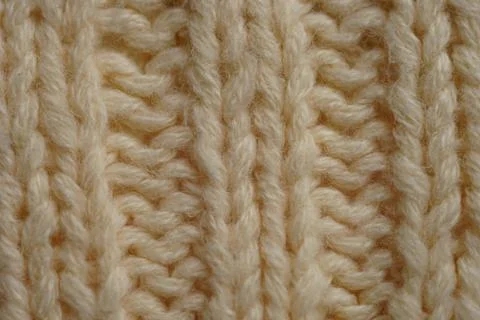 Yellow background of knitted thread pattern closeup. Stockfoto's