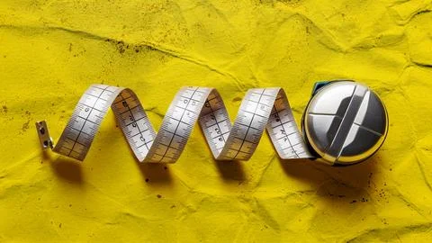 On a yellow background, a measuring tape Stock Illustration