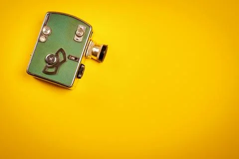 Yellow background with an old camera Stock Photos