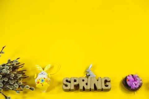 Yellow background with palm catkins, tulips and Easter bunny, copy space Stock Photos
