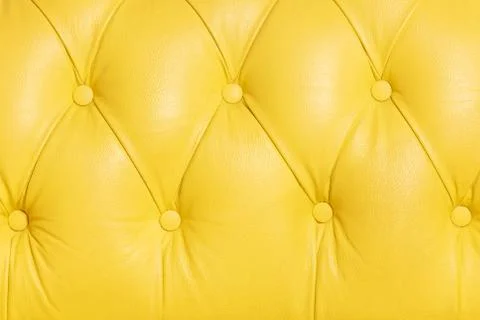 Yellow background pattern of a chesterfield leather sofa Stock Photos