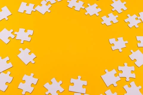 Yellow background with puzzle Stock Photos