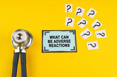 On a yellow background, a stethoscope, question marks and a sticker with th.. Stock Photos