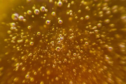 Yellow background, texture with bubbles in some liquid. Stock Photos