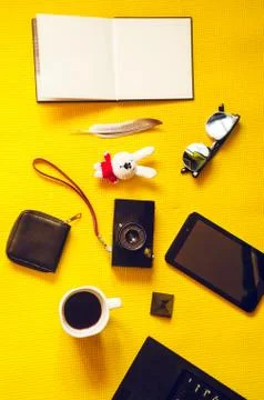 Yellow background. view from above. camera, notepad empty, toy, glasses, tabl Fotos Stock