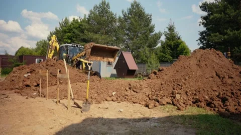 Yellow backhoe loader moving soil at construction site Stock Footage 341294342
