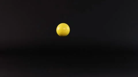 Yellow Ball Bouncing on Black Surface Vídeo Stock 312305914