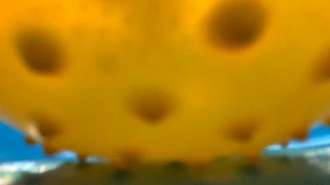 Yellow Ball Roll Down on a Water Slide to a Swimming Pool Stock Footage 125417545