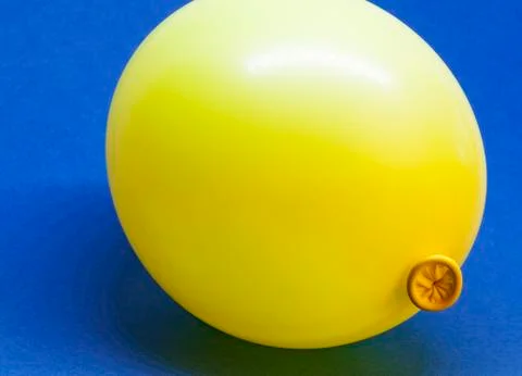 A yellow balloon on blue background Stock Photos