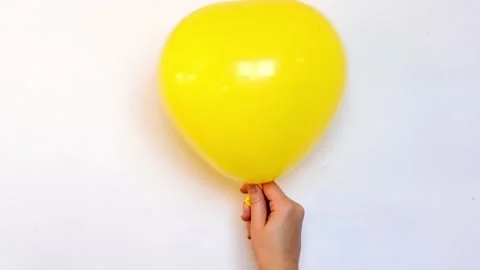 Yellow balloon in shape of heart inflating and deflating slowly video, symbol of Video stock 170332716