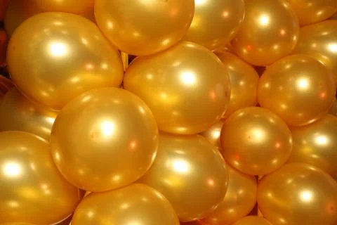 Yellow balloons background. Close up Stock Photos