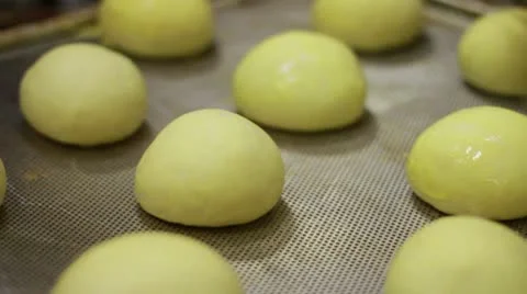 Yellow balls being buttered Stock Footage 9434029