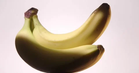 Yellow Bananas rotating on White Background Stock Footage 330938315