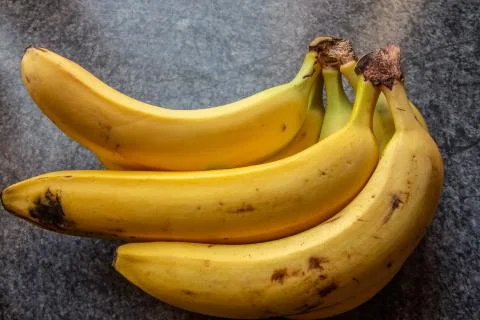 Yellow bananas on table Stock Photos