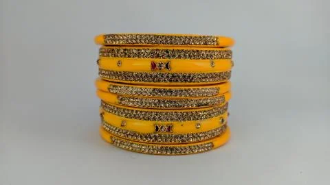 Yellow bangles isolated on white background - wedding / Traditional gold bang Stock Photos