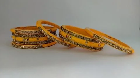 Yellow bangles isolated on white background - wedding / Traditional gold bang Stock Photos