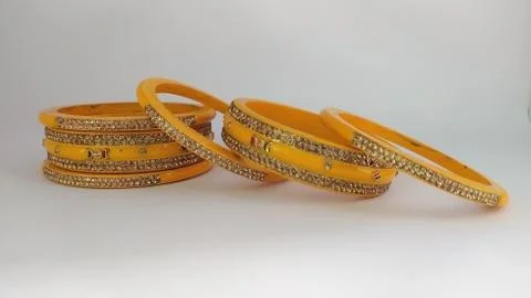 Yellow bangles isolated on white background - wedding / Traditional gold bang Stock Photos