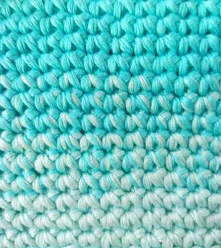 Yellow basket with yellow yarn for knitting. Stock Photos