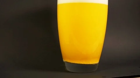 Yellow bath salt dissolves in vase of water in slowmotion with particle drilling Stock Footage 119033028