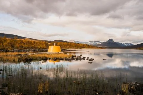 Yellow beacon tower at border intersection of Finland Sweden Norway Stock Photos