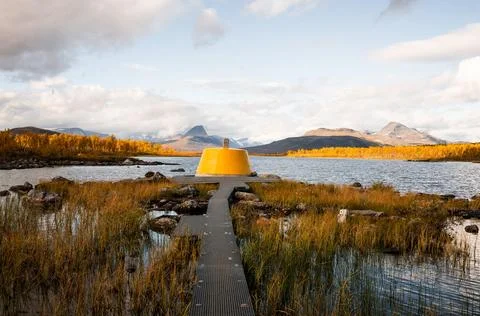Yellow beacon tower at border intersection of Finland Sweden Norway Stock Photos