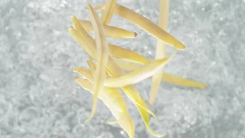 Yellow Beans Falling into Pot of Boiling Water Stock Footage 271399115