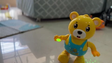 Yellow bear interactive toy dancing with colored lights projecting from Video stock 282861581