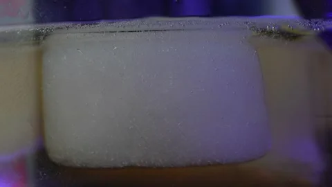 Yellow beer close up, macro shot .Pouring beer with bubbles and foam in glass Stock Footage 173117646